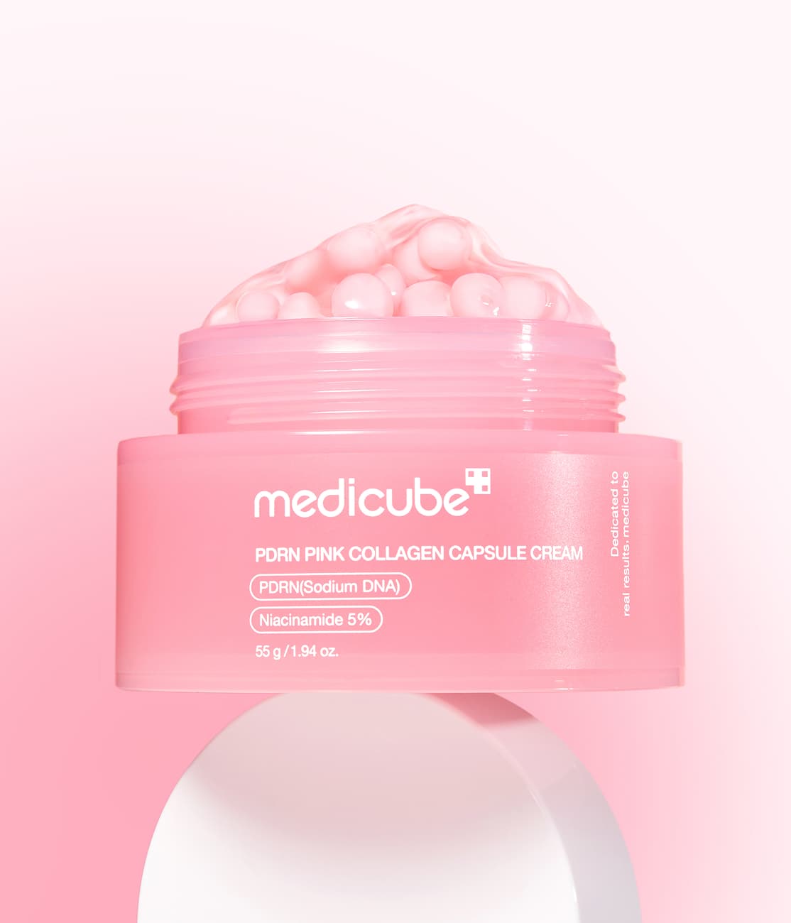 Pink medical capsules arranged for a beauty and wellness product concept